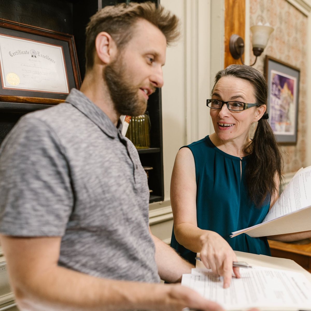 Colleagues reviewing research materials together in a workshop setting